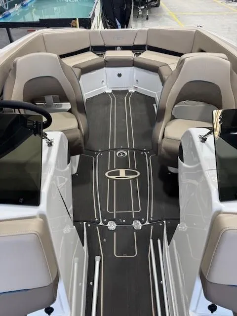 Slide: The Image of 2024 Tahoe 210 S Limited boat interior with beige seating and sleek design. - 12