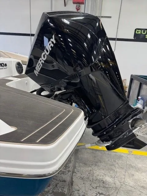 Slide: The Image of 2024 Tahoe 210 S Limited boat with a Mercury outboard motor in a showroom. - 5