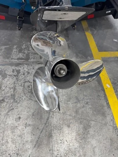 Slide: The Image of 2024 Tahoe 210 S Limited boat propeller on concrete surface, close-up view. - 6