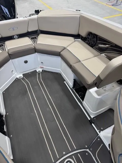 Slide: The Image of 2024 Tahoe 210 S Limited boat interior with beige seating and sleek flooring. - 9