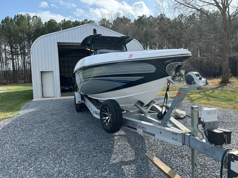 Slide: The Image of 2020 Sunsation 32 CCX boat on trailer outside a metal storage building. - 5