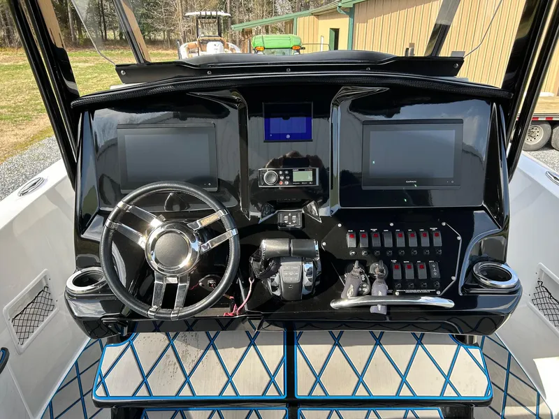 Slide: The Image of 2020 Sunsation 32 CCX boat dashboard with dual screens and modern controls. - 7