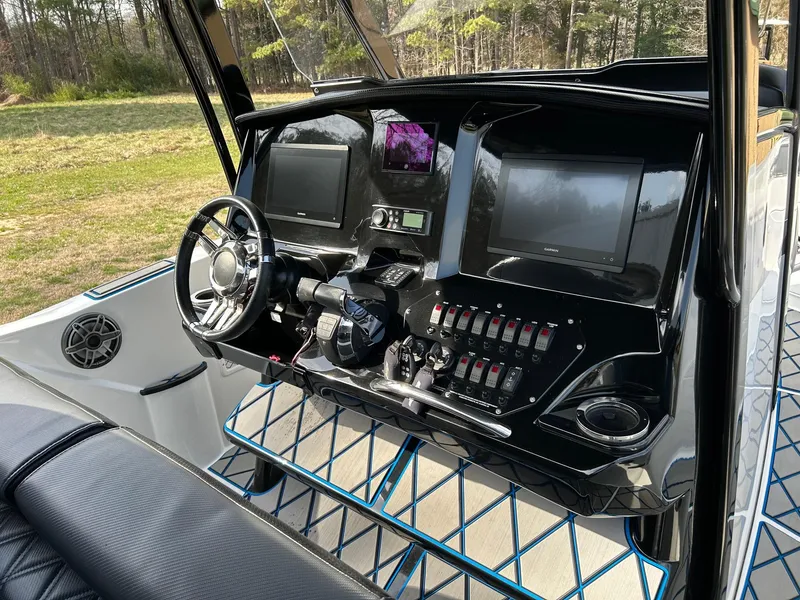 Slide: The Image of 2020 Sunsation 32 CCX boat dashboard with modern controls and dual screens. - 8