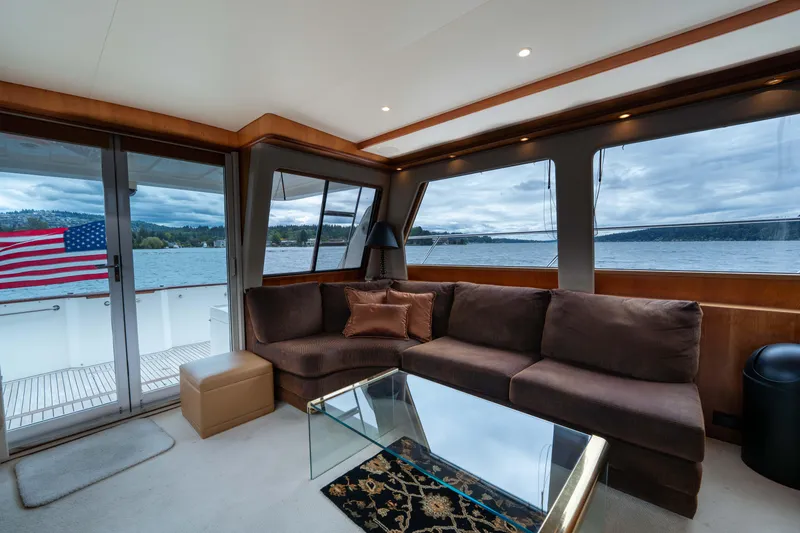 Slide: The Image of Luxurious interior of 2001 West Bay 58 RPH yacht with plush seating and scenic water views. - 12