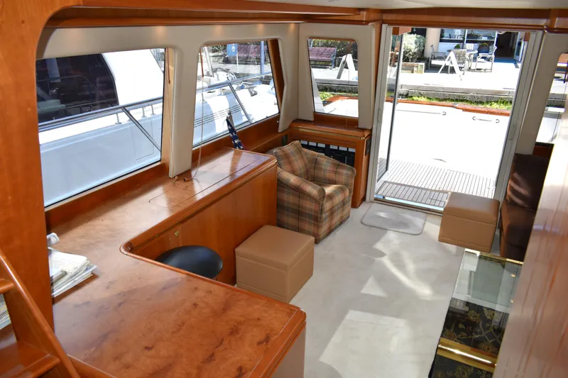 Slide: The Image of Interior of 2001 West Bay 58 RPH yacht with wood finish and seating area. - 15