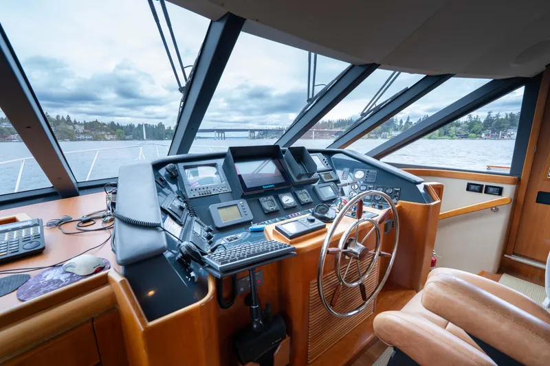 Slide: The Image of Helm of 2001 West Bay 58 RPH yacht with navigation equipment and panoramic windows. - 25