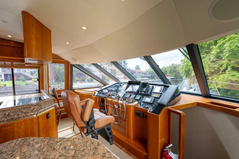 Slide: The Image of Luxurious 2001 West Bay 58 RPH yacht helm with modern controls and panoramic windows. - 26