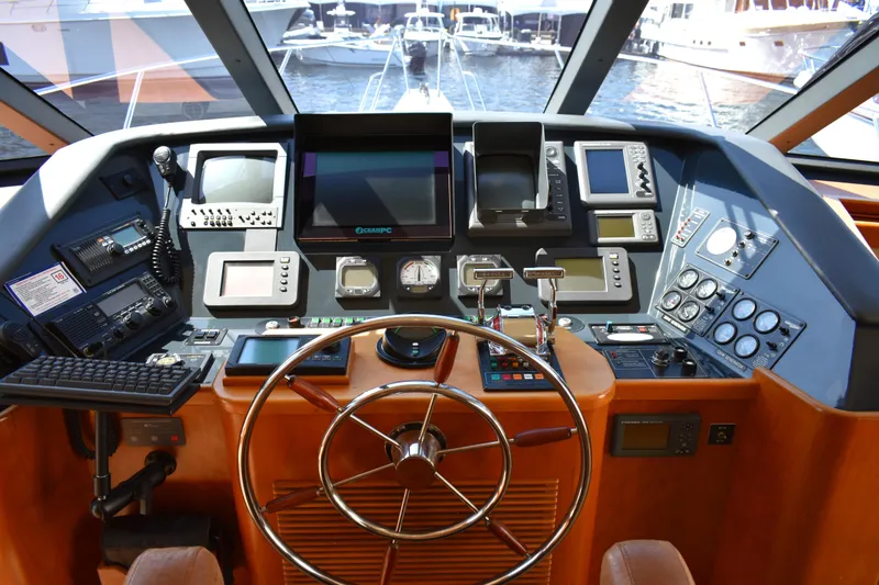 Slide: The Image of Helm of 2001 West Bay 58 RPH yacht with advanced navigation equipment and steering wheel. - 28