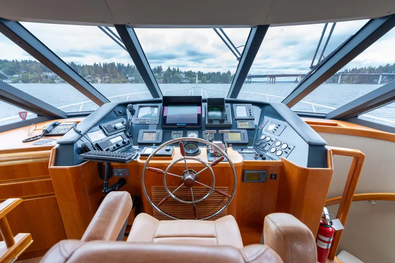 Slide: The Image of Helm of 2001 West Bay 58 RPH yacht with navigation instruments and leather seating. - 30