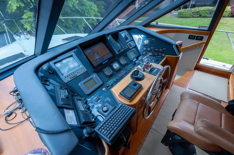 Slide: The Image of Cockpit of 2001 West Bay 58 RPH yacht with navigation instruments and leather chair. - 32