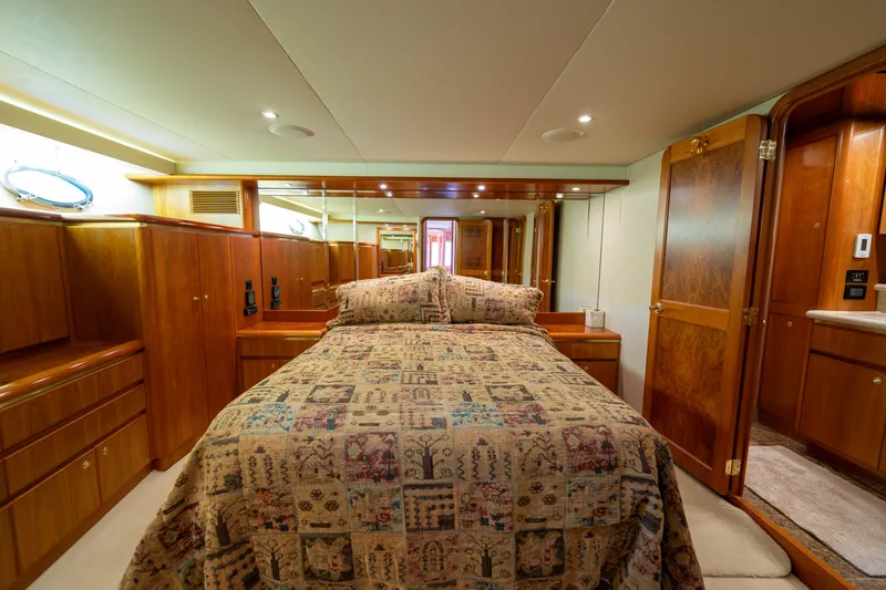 Slide: The Image of Luxurious bedroom interior of 2001 West Bay 58 RPH yacht with elegant wood finishes. - 34
