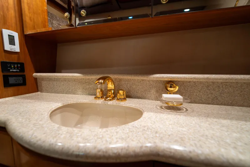 Slide: The Image of Luxurious bathroom sink with gold fixtures on a 2001 West Bay 58 RPH yacht. - 40