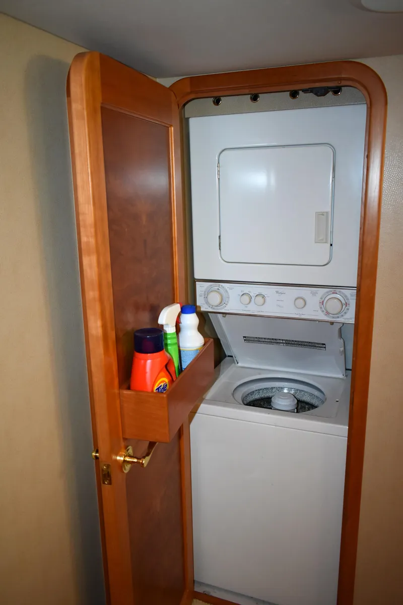 Slide: The Image of 2001 West Bay 58 RPH yacht laundry area with stacked washer and dryer. - 43