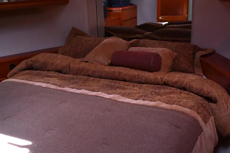 Slide: The Image of Luxurious bedroom interior of 2001 West Bay 58 RPH yacht with elegant bedding. - 48