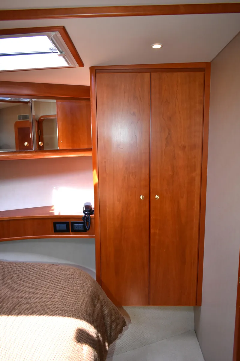 Slide: The Image of Interior of 2001 West Bay 58 RPH yacht with wooden cabinetry and cozy bedroom. - 49