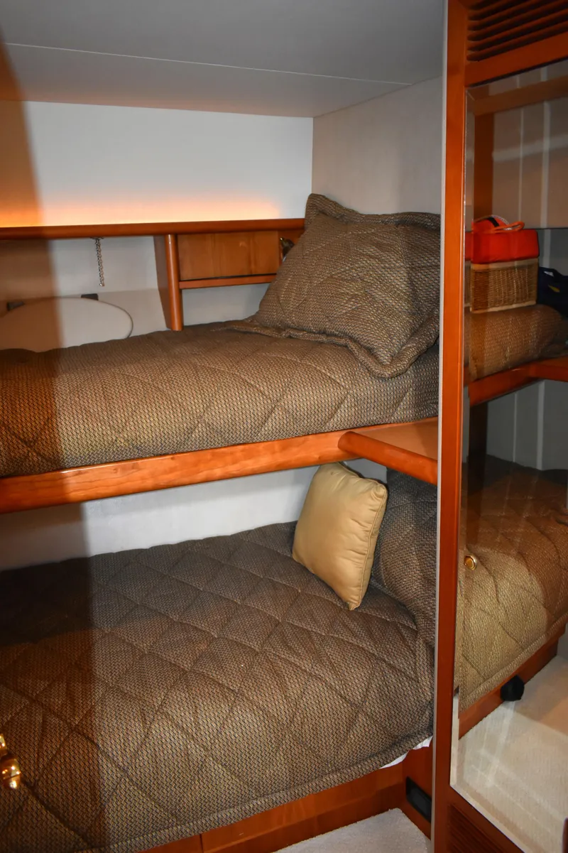 Slide: The Image of Bunk beds in 2001 West Bay 58 RPH yacht cabin with cozy bedding. - 52