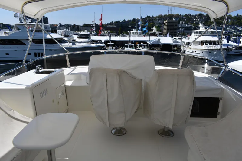 Slide: The Image of Flybridge view of 2001 West Bay 58 RPH yacht in marina setting. - 62