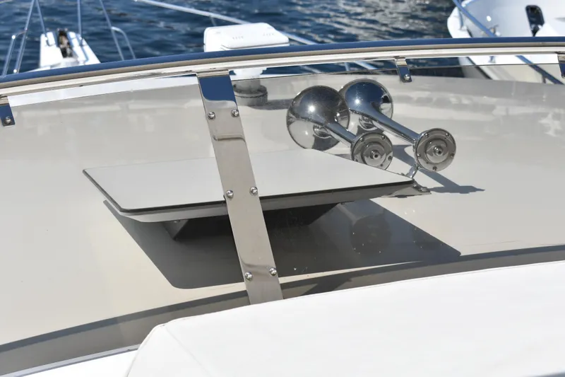 Slide: The Image of 2001 West Bay 58 RPH yacht deck with chrome details and ocean backdrop. - 64