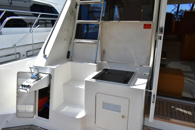 Slide: The Image of 2001 West Bay 58 RPH yacht deck with ladder and built-in grill. - 68