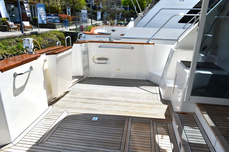 Slide: The Image of 2001 West Bay 58 RPH yacht deck with wooden flooring and sleek design. - 69
