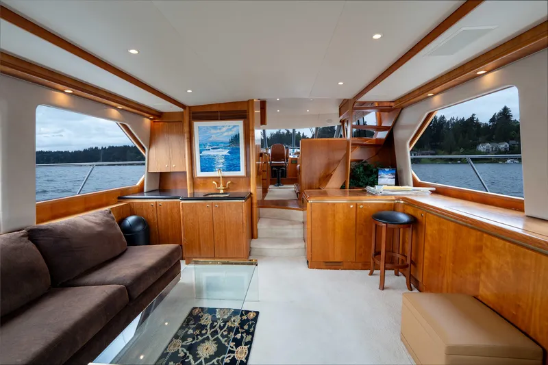 Slide: The Image of Luxurious interior of 2001 West Bay 58 RPH yacht with elegant wood finishes and scenic views. - 7