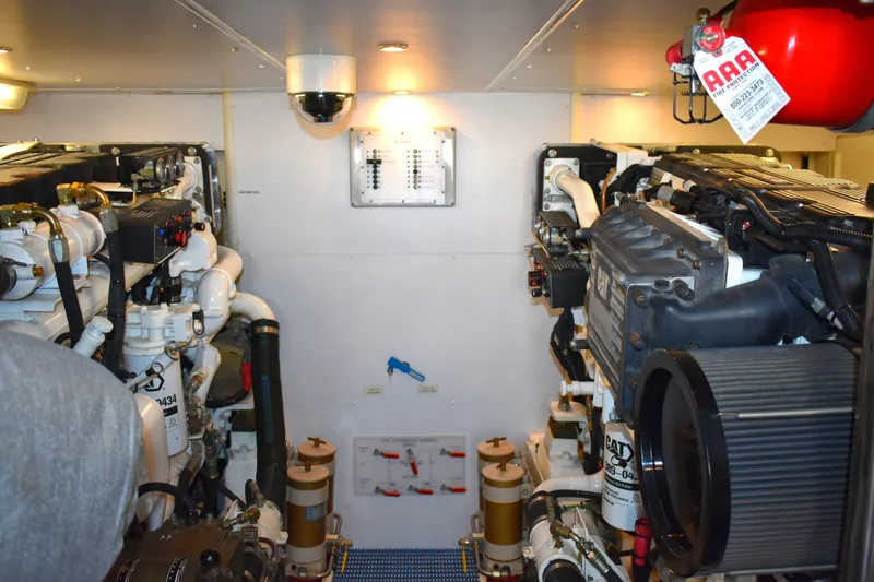 Slide: The Image of Engine room of 2001 West Bay 58 RPH yacht, featuring dual engines and control panel. - 71