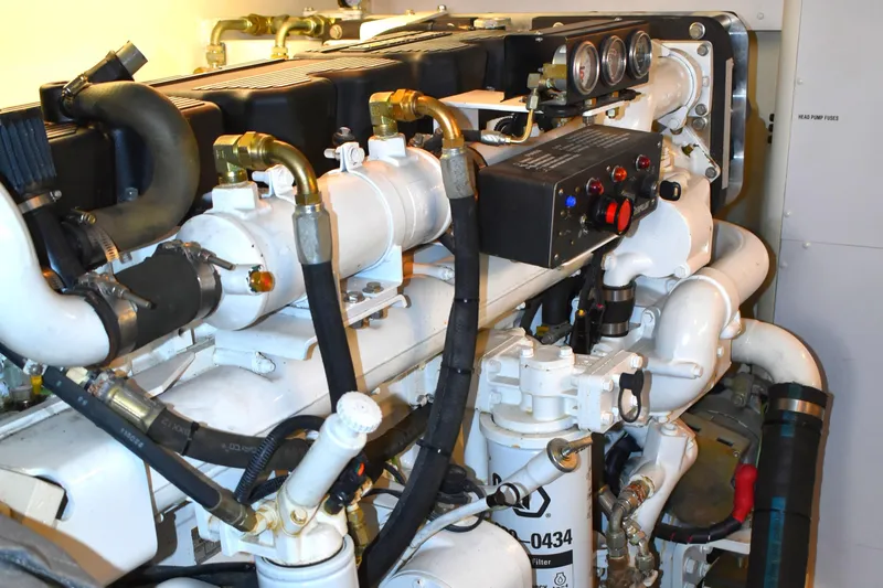 Slide: The Image of Engine room of 2001 West Bay 58 RPH yacht, showcasing complex machinery and gauges. - 73
