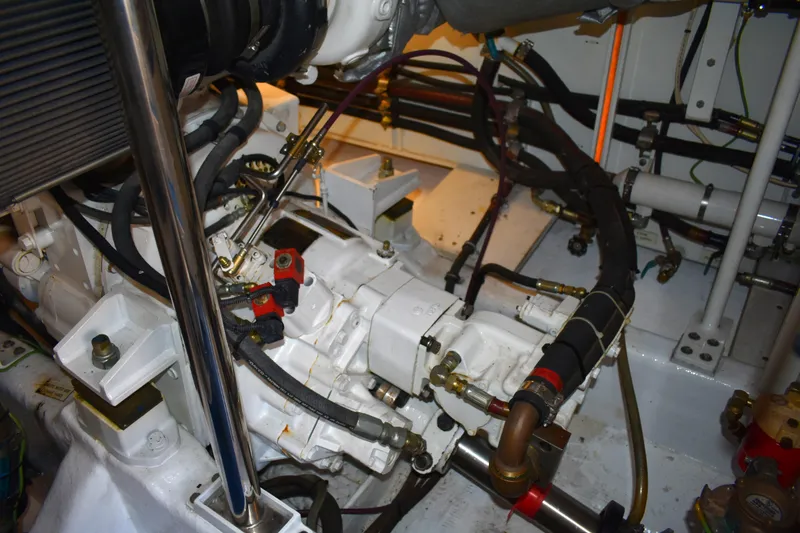 Slide: The Image of Engine room of 2001 West Bay 58 RPH yacht, showcasing mechanical components and hoses. - 76