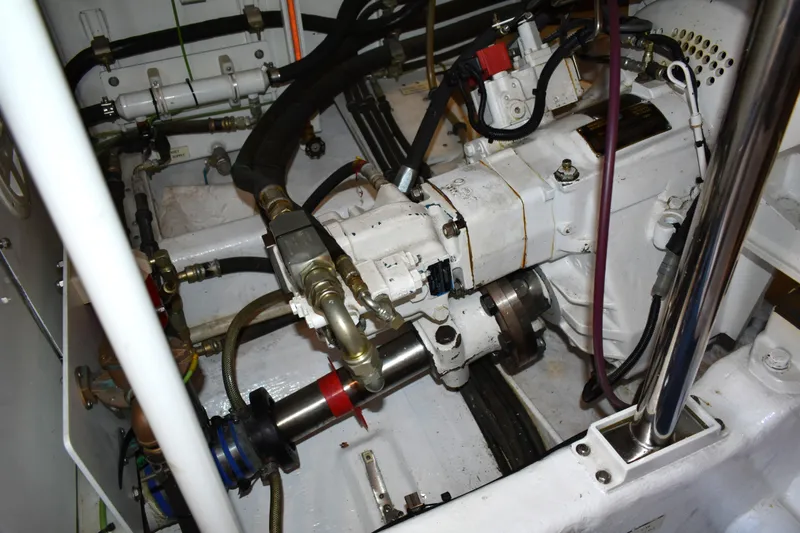 Slide: The Image of Engine room of 2001 West Bay 58 RPH yacht, showcasing mechanical components and piping. - 77