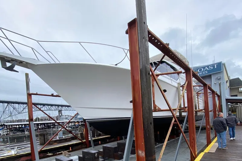 Slide: The Image of 2001 West Bay 58 RPH yacht on dry dock at a marina. - 79