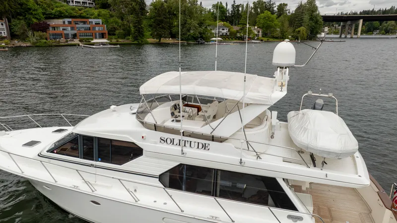 Slide: The Image of Luxury 2001 West Bay 58 RPH yacht "Solitude" on a serene lake. - 85