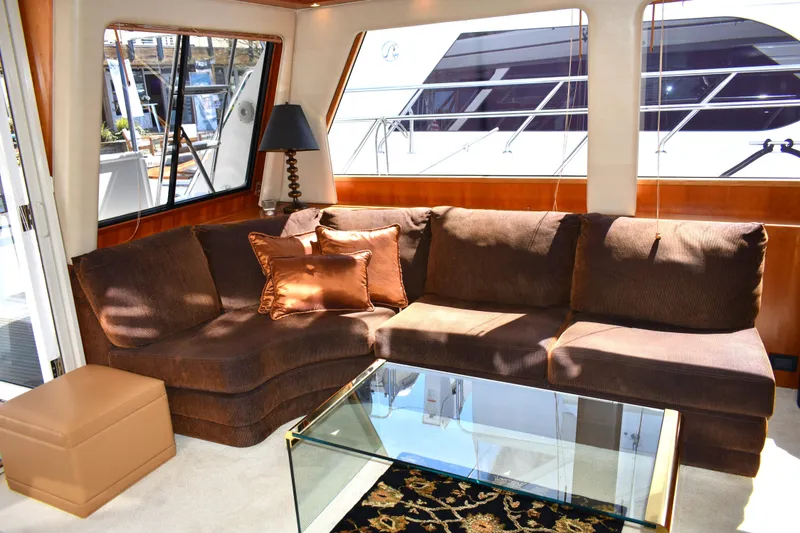 Slide: The Image of Luxurious interior of 2001 West Bay 58 RPH yacht with plush seating and glass table. - 9