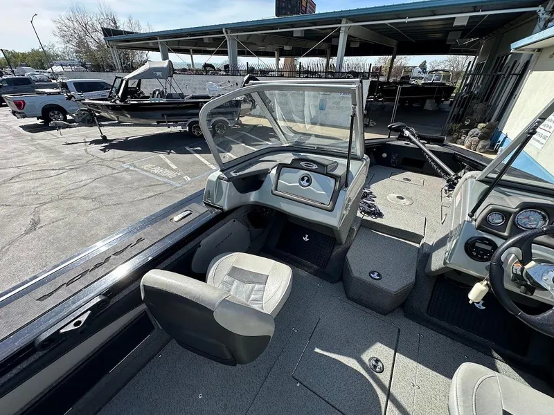 Slide: The Image of 2018 Tracker Targa V-19 WT boat interior with seating and dashboard. - 11