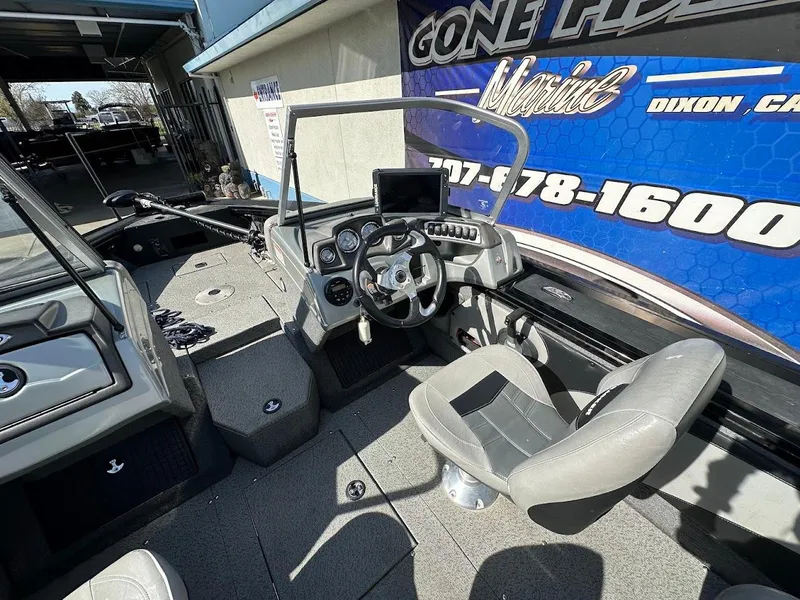 Slide: The Image of 2018 Tracker Targa V-19 WT boat interior with steering wheel and dashboard controls. - 12