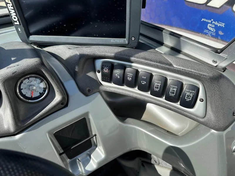 Slide: The Image of Control panel of a 2018 Tracker Targa V-19 WT boat with switches and gauge. - 17