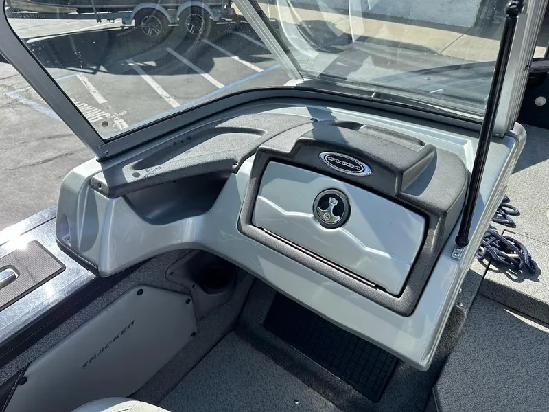 Slide: The Image of 2018 Tracker Targa V-19 WT boat dashboard with open glove compartment. - 18