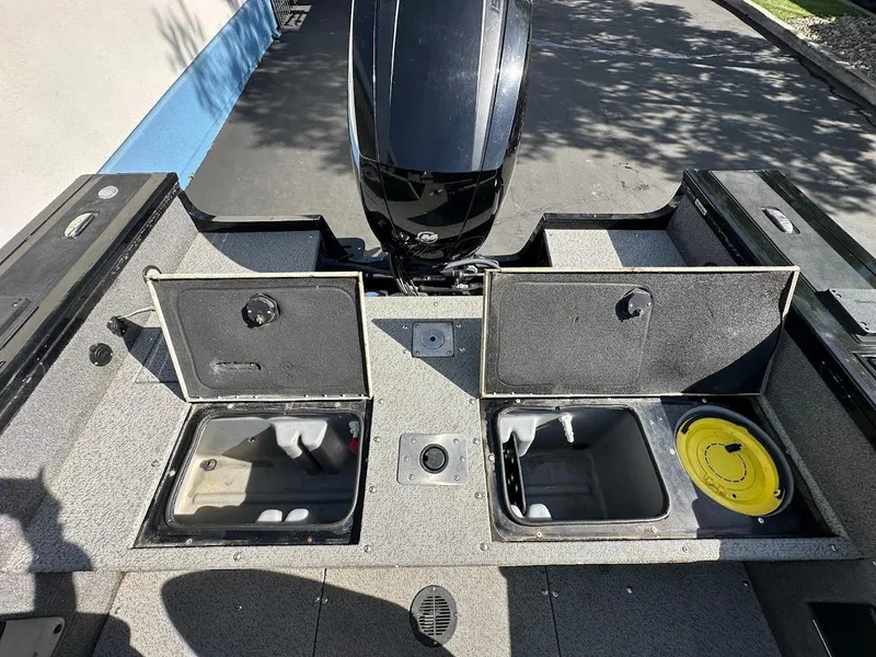 Slide: The Image of 2018 Tracker Targa V-19 WT boat storage compartments and engine view. - 22