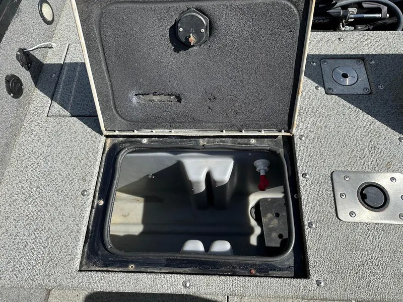 Slide: The Image of 2018 Tracker Targa V-19 WT boat storage compartment open, showing interior details. - 23