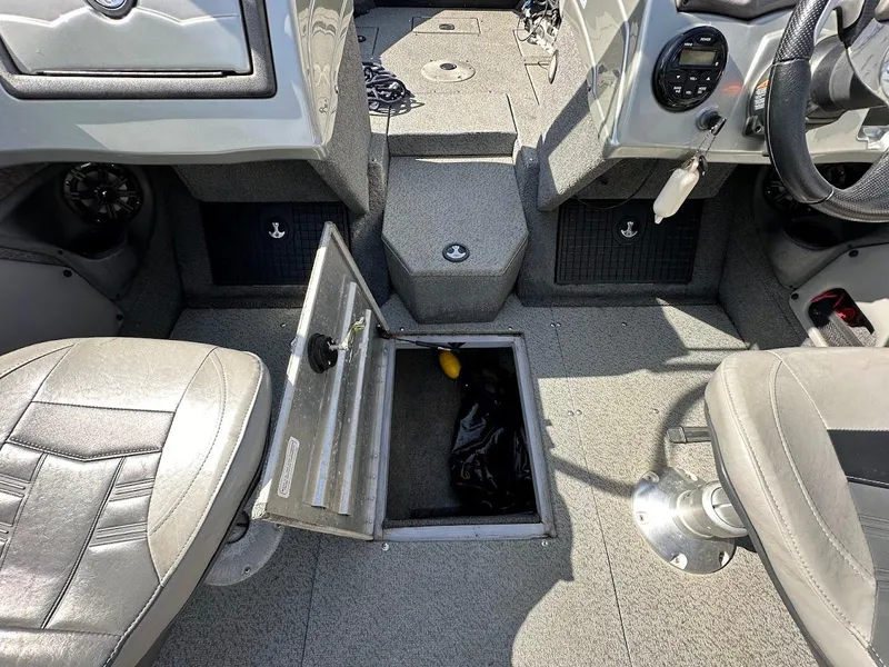 Slide: The Image of 2018 Tracker Targa V-19 WT boat interior with open storage compartment. - 26