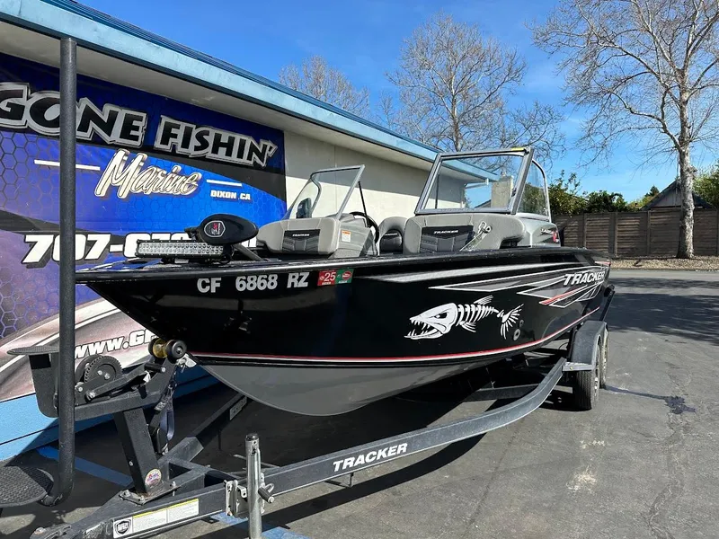 Slide: The Image of 2018 Tracker Targa V-19 WT boat on trailer, parked outside a fishing store. - 5
