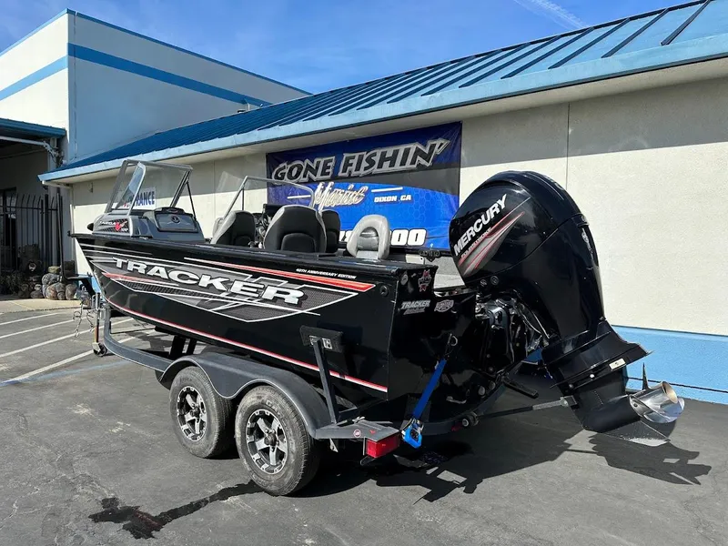 Slide: The Image of 2018 Tracker Targa V-19 WT boat on trailer, parked outside a building. - 7