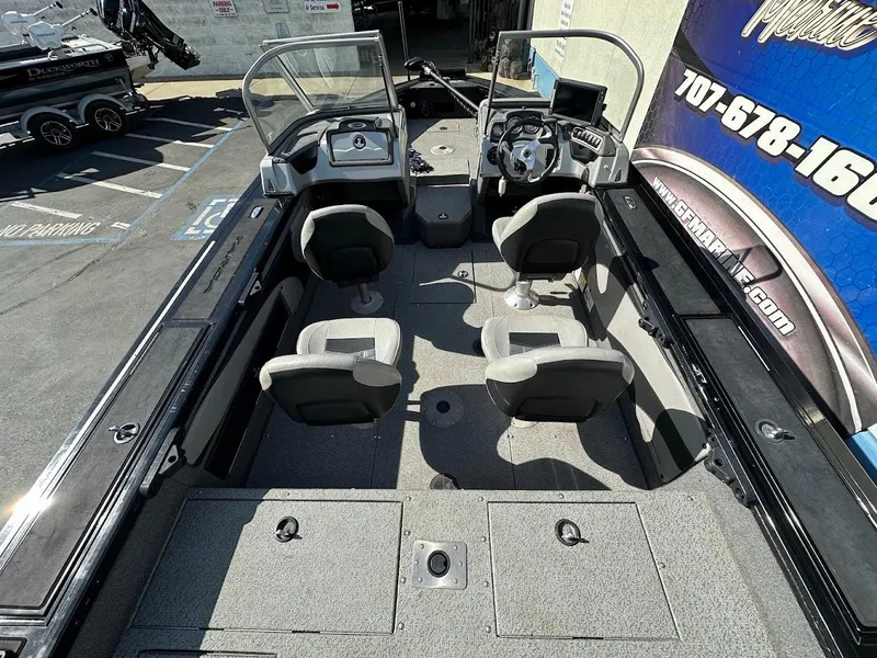 Slide: The Image of 2018 Tracker Targa V-19 WT boat interior with four seats and steering console. - 9