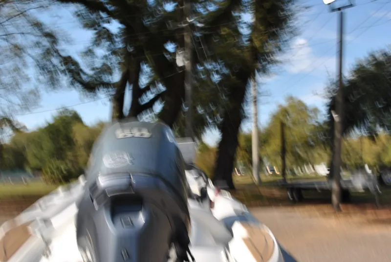 Slide: The Image of Blurry image of a 2017 Avon Seasport 340 Deluxe boat outdoors. - 11