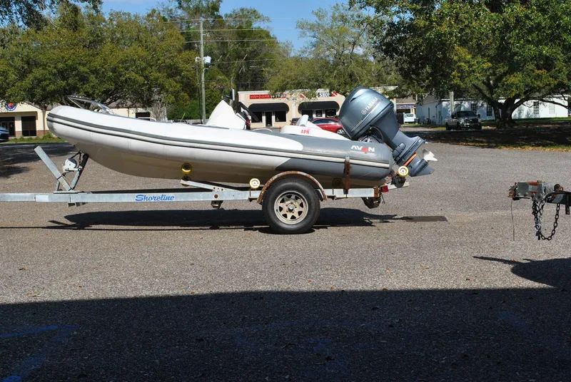 Slide: The Image of 2017 Avon Seasport 340 Deluxe boat on trailer in parking lot. - 2