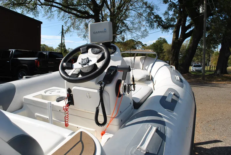 Slide: The Image of 2017 Avon Seasport 340 Deluxe boat with Garmin navigation, parked outdoors. - 23