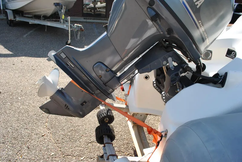 Slide: The Image of 2017 Avon Seasport 340 Deluxe outboard motor on trailer, secured with orange strap. - 29