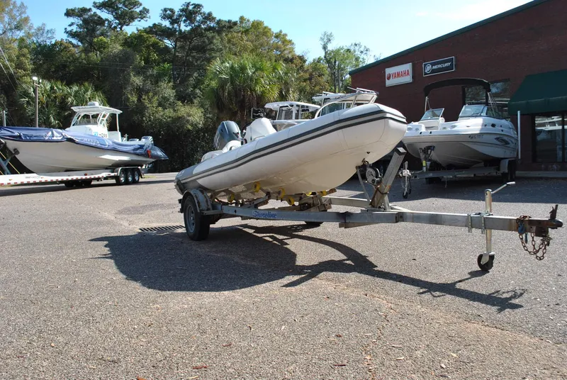 Slide: The Image of 2017 Avon Seasport 340 Deluxe boat on trailer in outdoor dealership lot. - 6