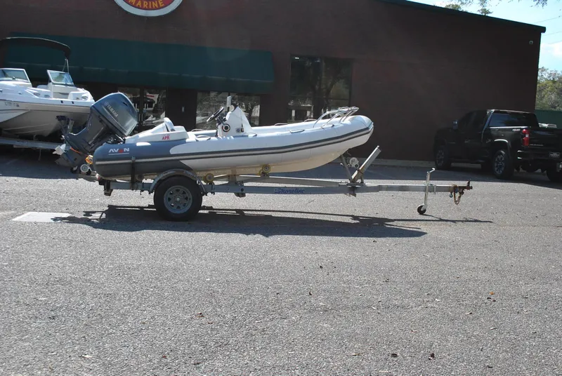 Slide: The Image of 2017 Avon Seasport 340 Deluxe inflatable boat on trailer, parked outdoors. - 7
