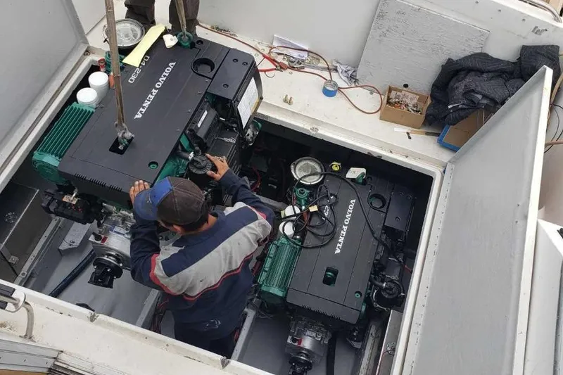 Slide: The Image of Mechanic working on Volvo Penta engines in a 1991 Wellcraft Triumph 34 boat. - 16