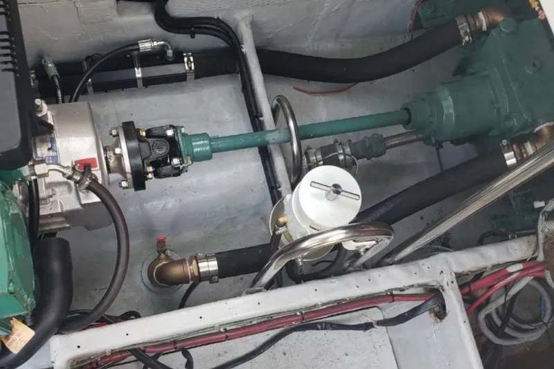 Slide: The Image of Engine compartment of a 1991 Wellcraft Triumph 34 boat, showcasing mechanical components and wiring. - 17